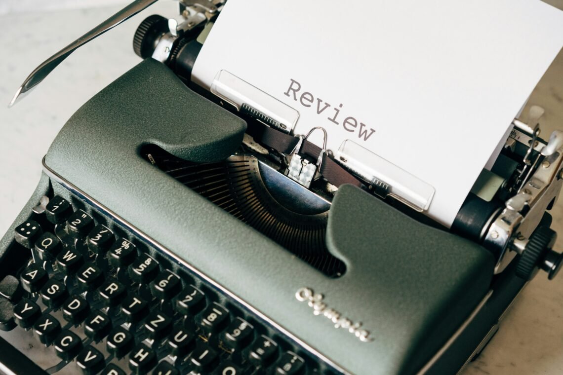 typewriter with review on page